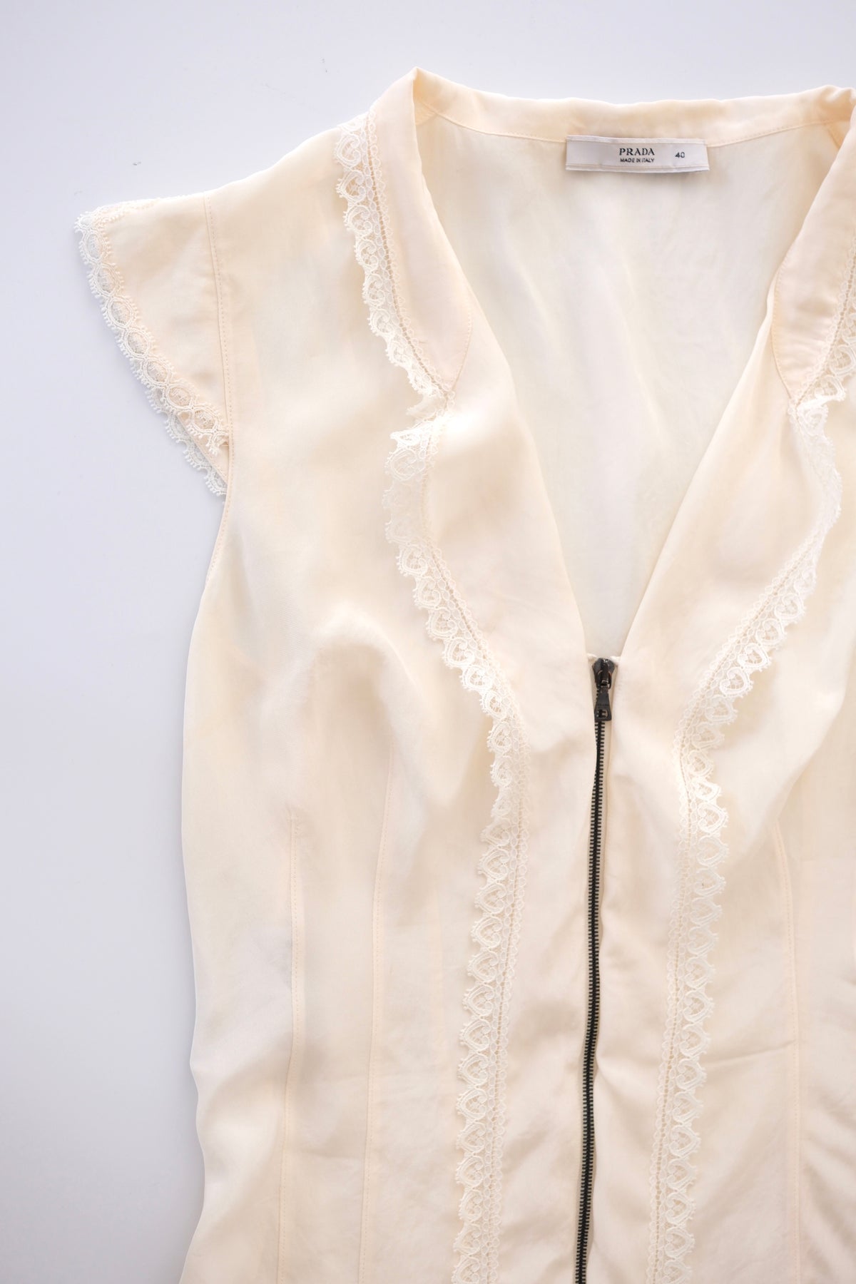 Prada semi-sheer cream zip-up blouse