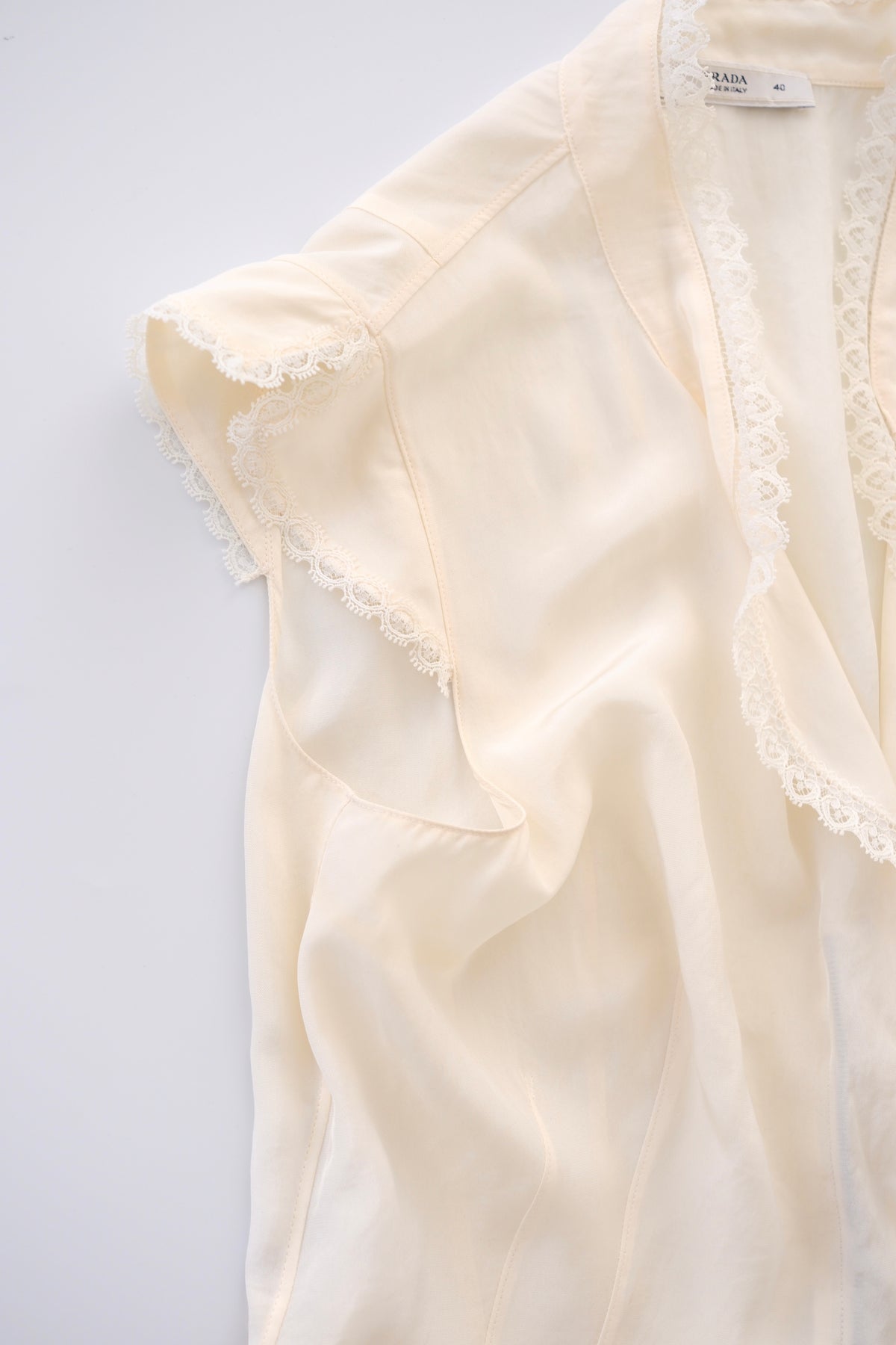 Prada semi-sheer cream zip-up blouse